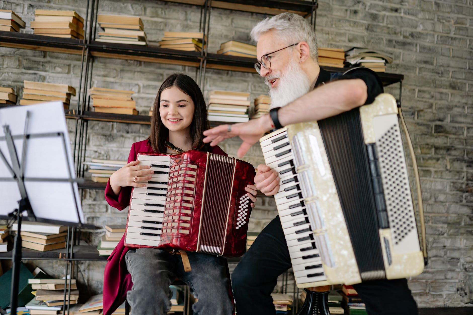 a man and a girl playing accordions